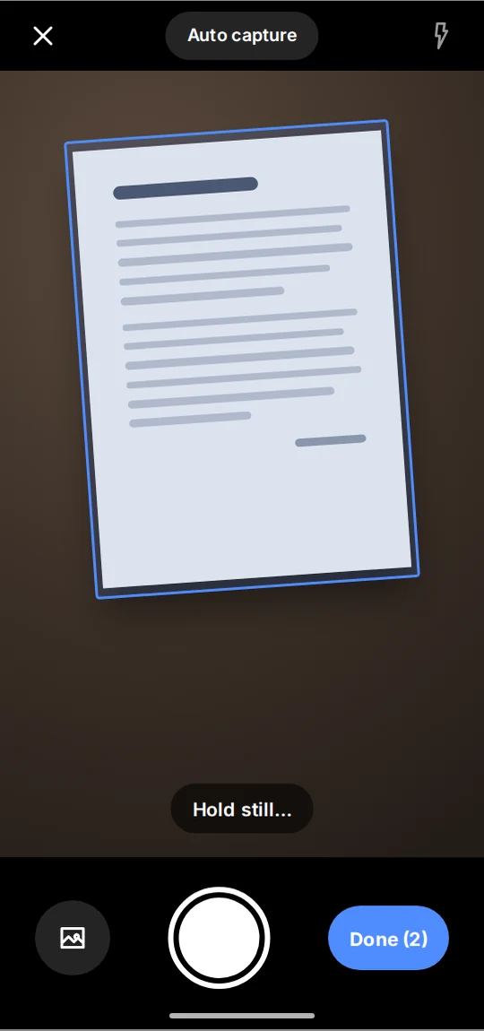 Keepscan's camera outlining a page in blue, with the hint Hold still